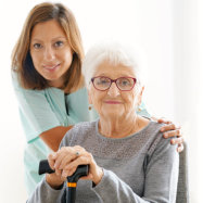 senior woman along with her caregiver smiling