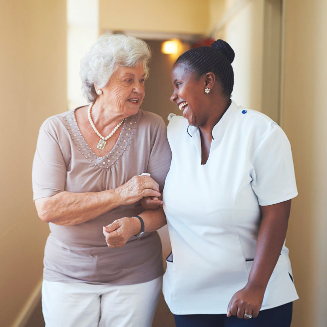 caregiver and a senior woman having conversation