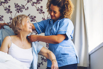 caregiver assisting senior woman